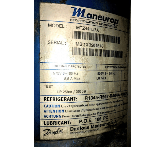 Close-up of a Maneurop reciprocating compressor label, detailing model MTZ44HJ7A, serial MB 10 3201013, refrigerant R134a-R507-R404A-R407C, and various technical specifications.