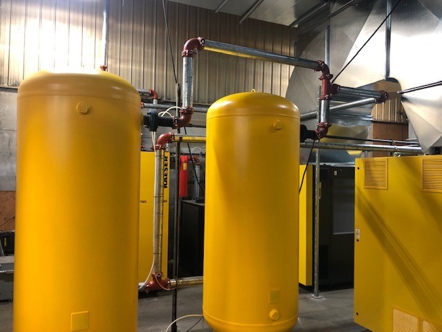 A yellow cylinder tanks in a factory

Description automatically generated with medium confidence