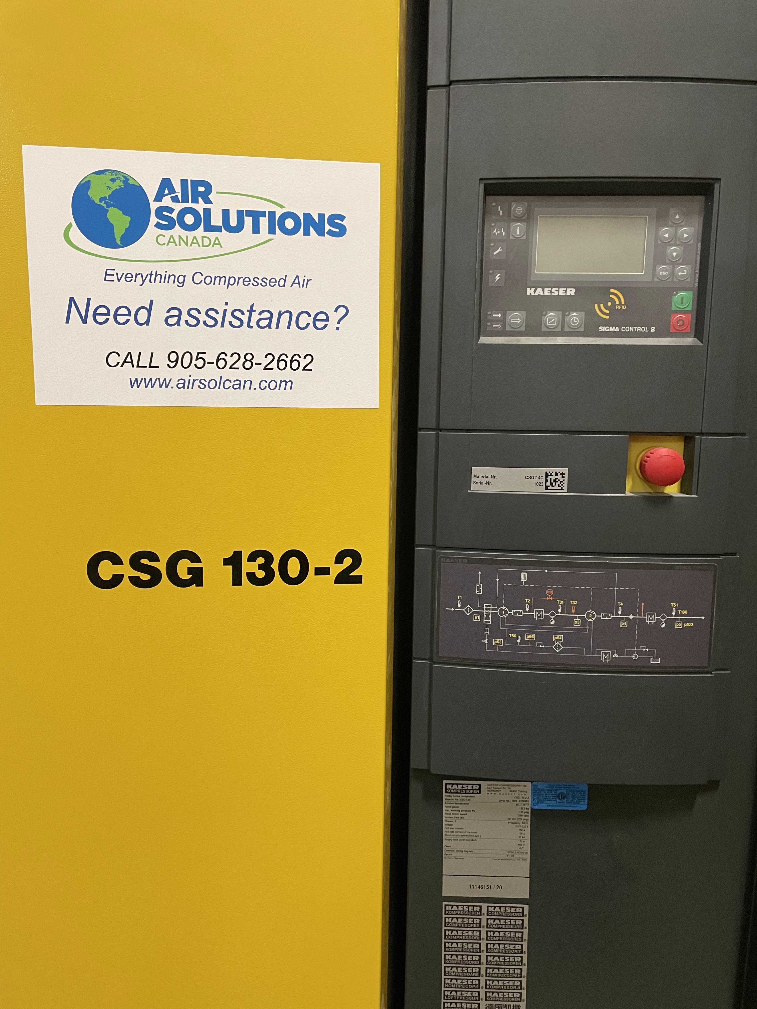 A yellow and black air compressor labeled "CSG 130-2" with a control panel and an Air Solutions Canada service sticker with contact information.