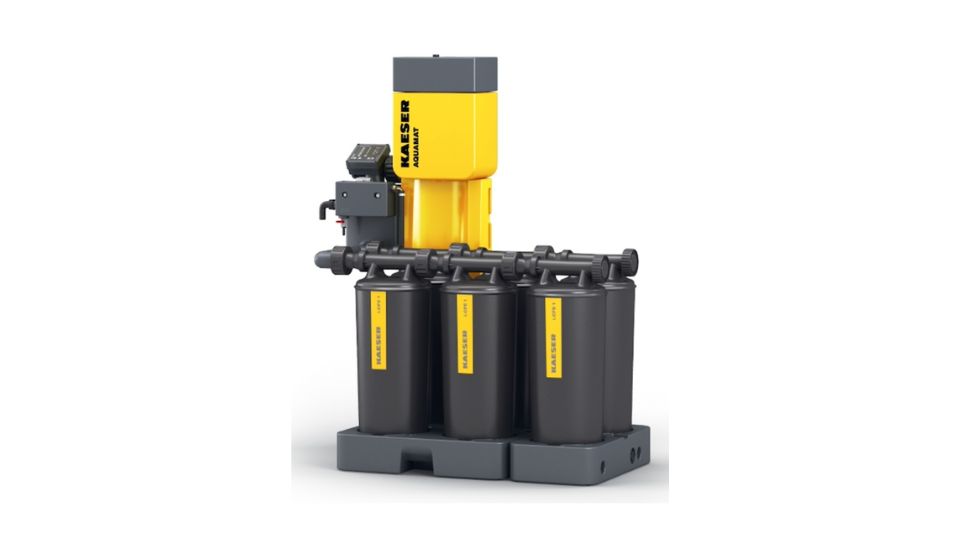 Industrial air compressor system featuring three vertical cylinders and a yellow compressor unit at the top. The system includes multiple control valves and is mounted on a gray base.